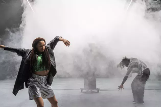 Two people dancing in a misty room. Photo. 